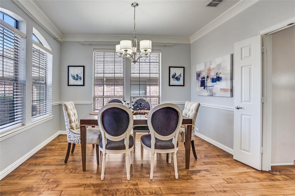 1804 Goodnight Lane Allen, TX 75002 - Photo 12 of 35 Dining room featuring ornamental molding, solid hardwood flooring, and a chandelier