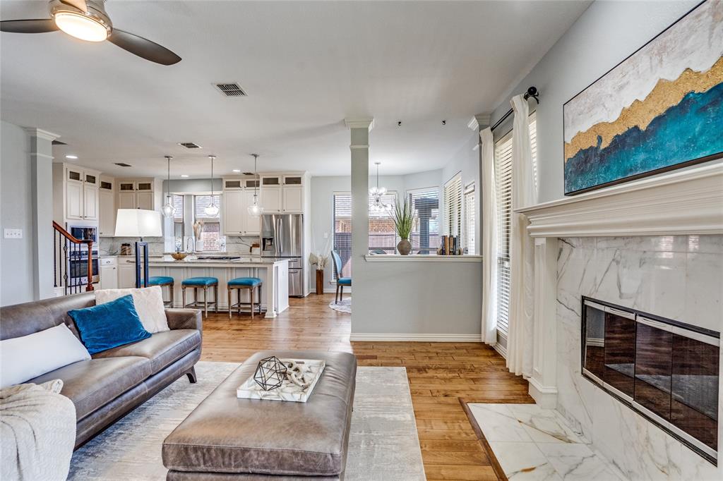 1804 Goodnight Lane Allen, TX 75002 - Photo 15 of 35 Living area featuring a high end fireplace, ceiling fan, solid hardwood flooring, and recessed lighting