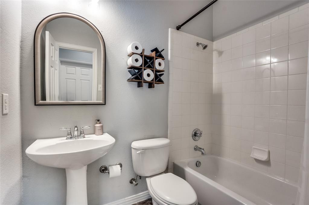 1804 Goodnight Lane Allen, TX 75002 - Photo 22 of 35 Full bath featuring bathing tub / shower combination and a textured wall