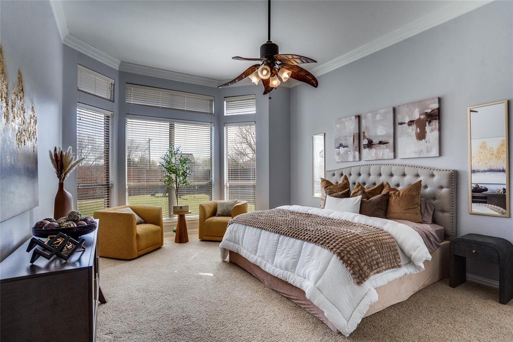1804 Goodnight Lane Allen, TX 75002 - Photo 31 of 35 Bedroom with light colored carpet, crown molding, and ceiling fan