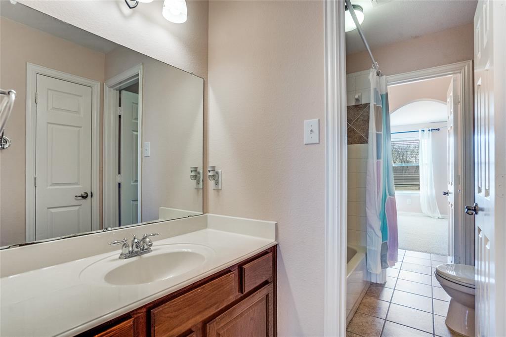 1804 Goodnight Lane Allen, TX 75002 - Photo 33 of 35 Bathroom with vanity, shower / tub combo, and light tile patterned flooring