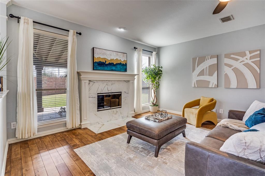 1804 Goodnight Lane Allen, TX 75002 - Photo 4 of 35 Living room featuring ceiling fan, hardwood / wood-style flooring, and a high end fireplace