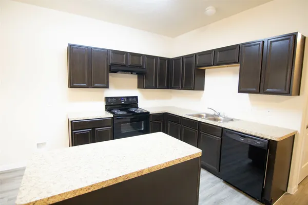 a kitchen with a sink and a refrigerator