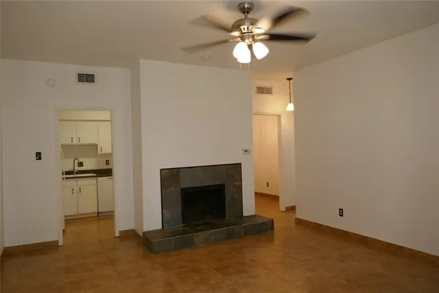 a view of empty room with a fireplace