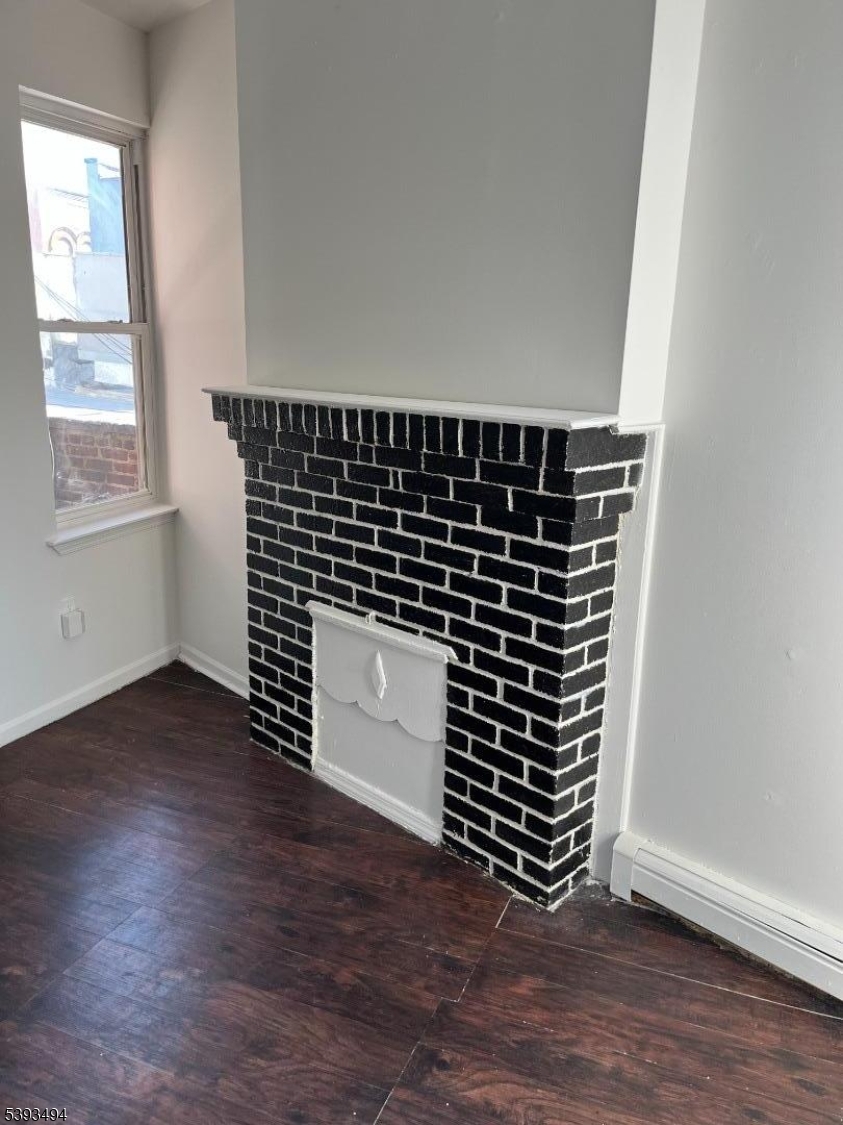 340 Morris Avenue Elizabeth, NJ 07208 - Photo 5 of 8 an empty room with wooden floor