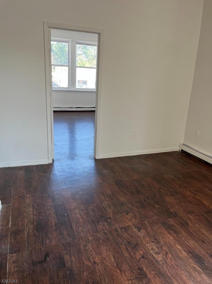 340 Morris Avenue Elizabeth, NJ 07208 - Photo 7 of 8 a view of an empty room with wooden floor and a window
