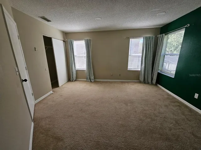 a view of a big room with windows and a projector