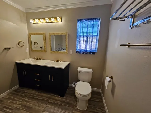 a bathroom with a sink toilet and mirror