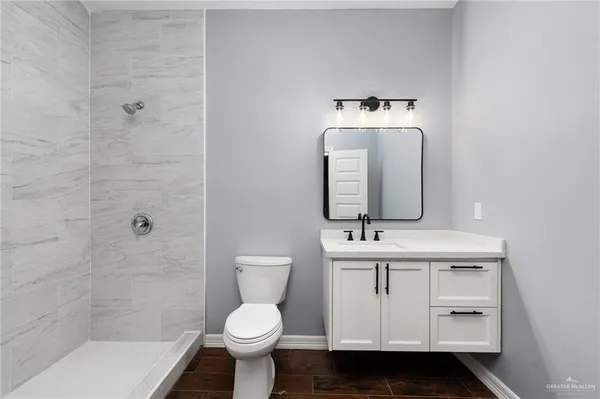 a bathroom with a sink toilet and shower