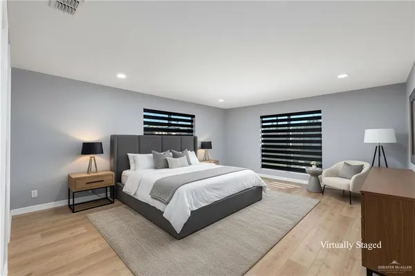 a spacious bedroom with a bed and a couch