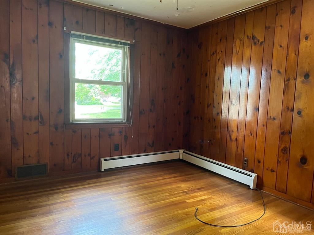 432 Oak Ridge Road Clark, NJ 07066 - Photo 11 of 25 an empty room with wooden floor and windows