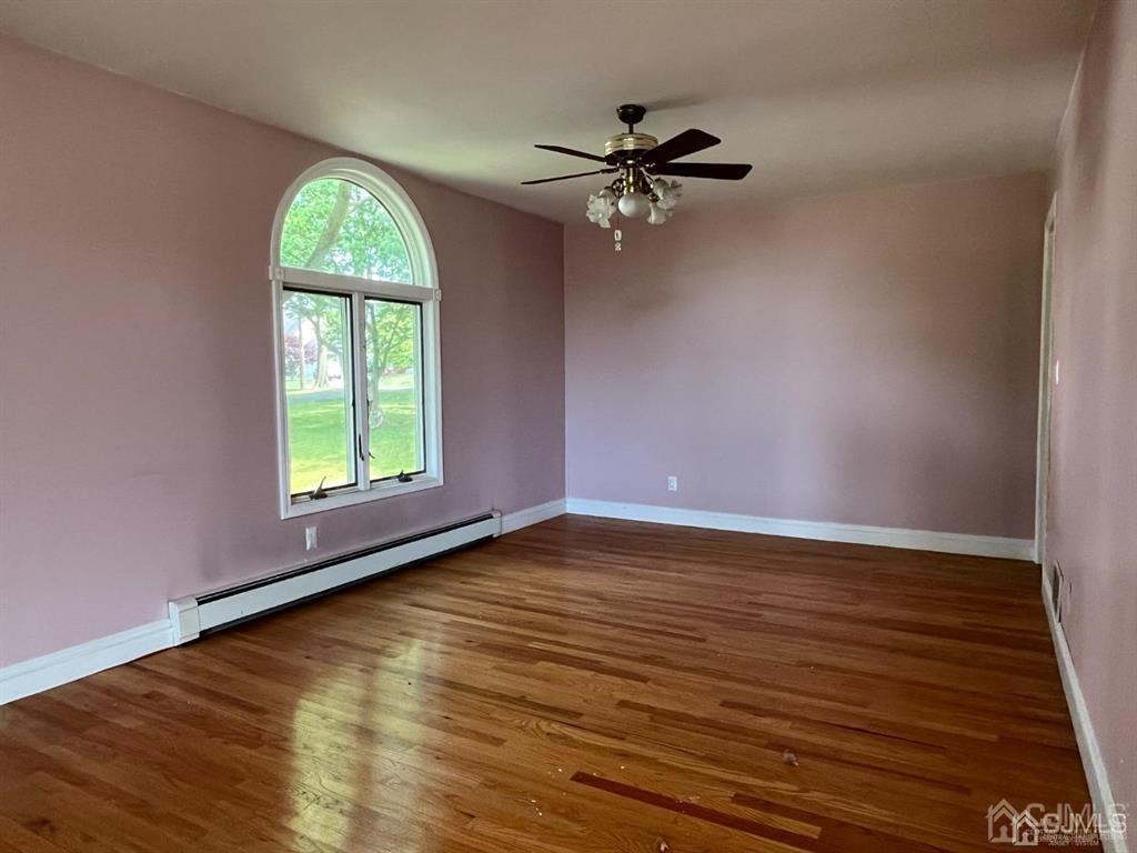 432 Oak Ridge Road Clark, NJ 07066 - Photo 5 of 25 wooden floor in an empty room with a window