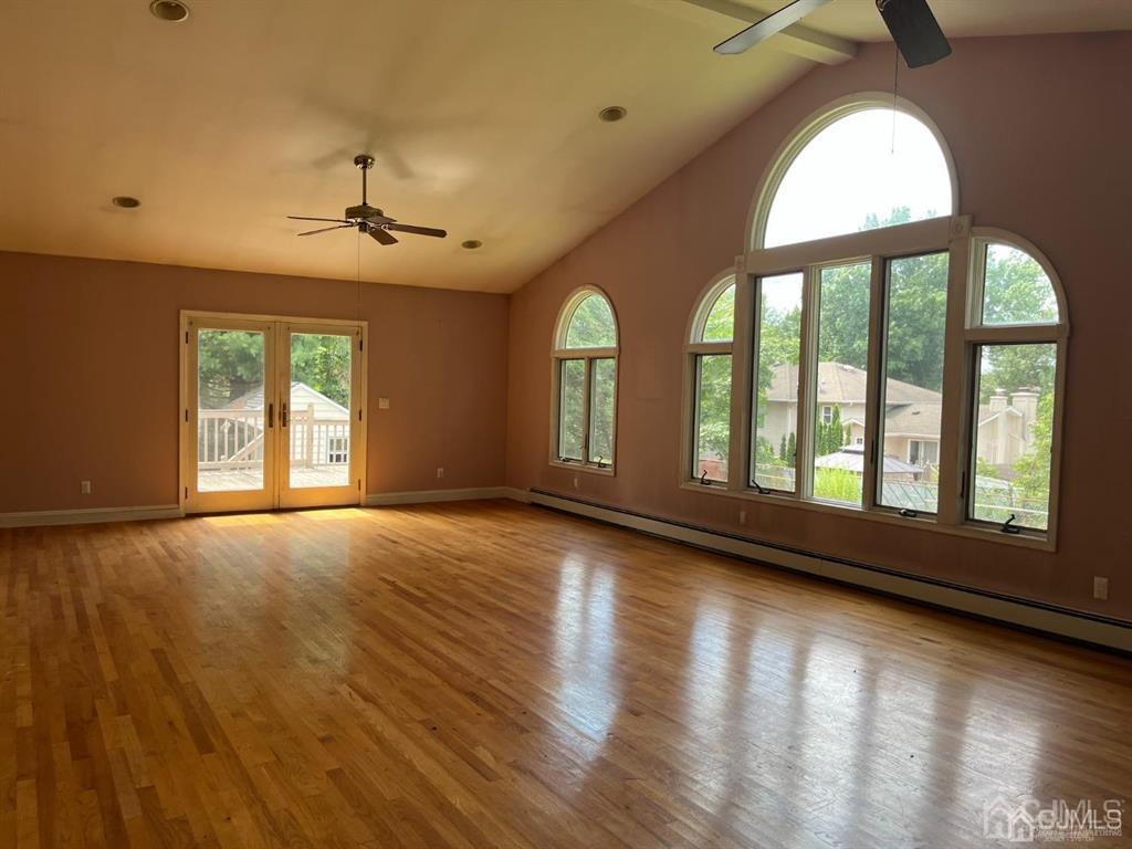 432 Oak Ridge Road Clark, NJ 07066 - Photo 6 of 25 a view of an empty room with wooden floor and a window