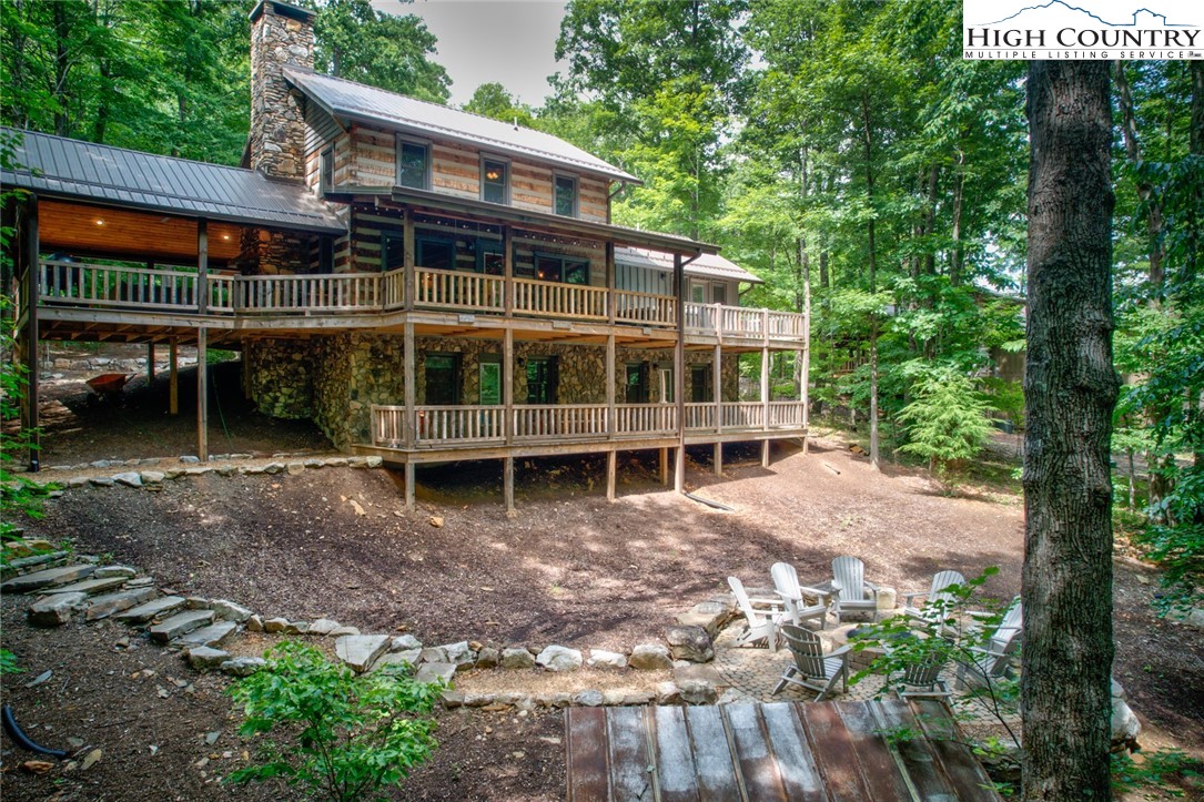 a view of house with a yard and sitting area
