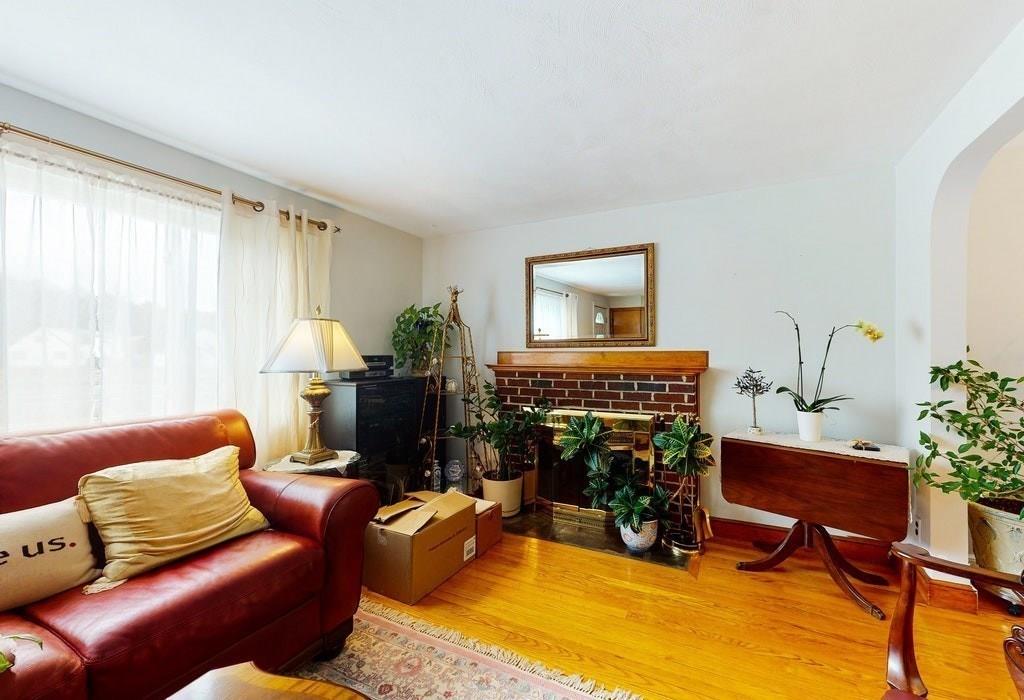 2 Wadsworth Road Arlington, MA 02476 - Photo 3 of 24 a living room with furniture a fireplace and a table