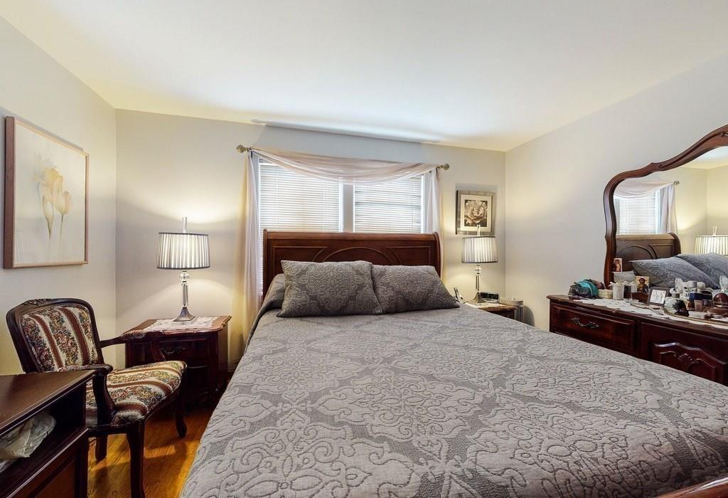 2 Wadsworth Road Arlington, MA 02476 - Photo 9 of 24 a bedroom with a bed and wooden floor