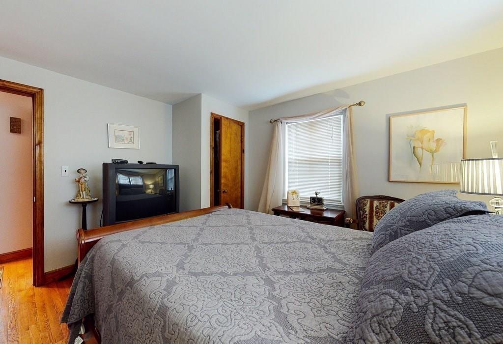 2 Wadsworth Road Arlington, MA 02476 - Photo 10 of 24 a bedroom with a bed and wooden floor