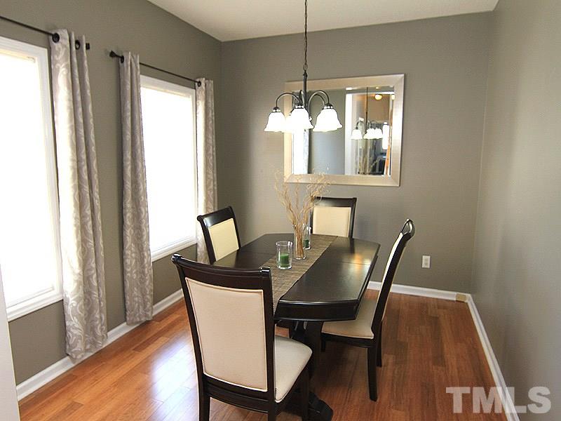 2109 Timken Court Raleigh, NC 27604 - Photo 11 of 21 a dining room with furniture a chandelier and wooden floor