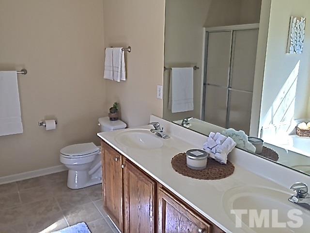 2109 Timken Court Raleigh, NC 27604 - Photo 15 of 21 a bathroom with a granite countertop sink and a toilet