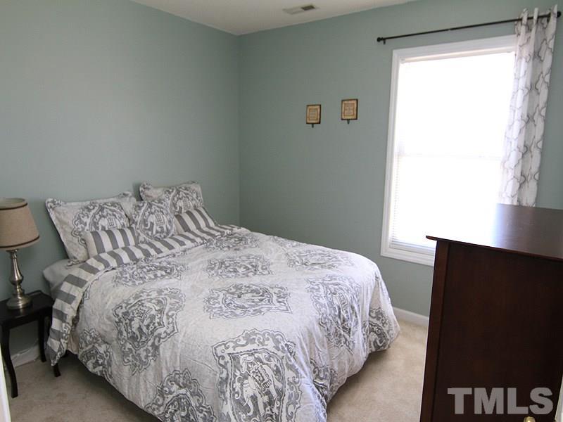 2109 Timken Court Raleigh, NC 27604 - Photo 16 of 21 a bedroom with a bed and a flat tv screen