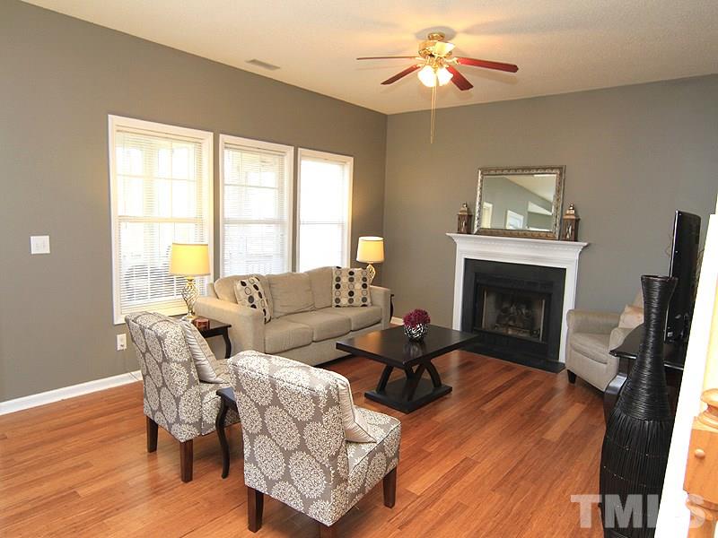2109 Timken Court Raleigh, NC 27604 - Photo 5 of 21 a living room with furniture a fireplace and a flat screen tv