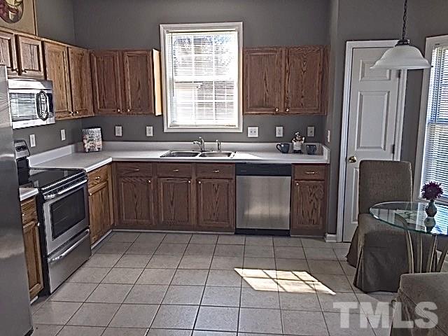 2109 Timken Court Raleigh, NC 27604 - Photo 8 of 21 a kitchen with a sink stove and cabinets
