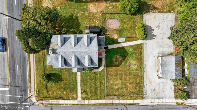 a view of a house with pool and chairs