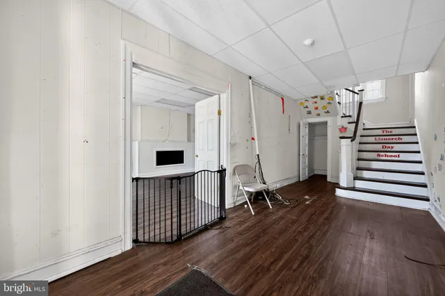 a view of an empty room with wooden and a window