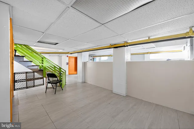 a view of a livingroom with wooden floor and a fireplace