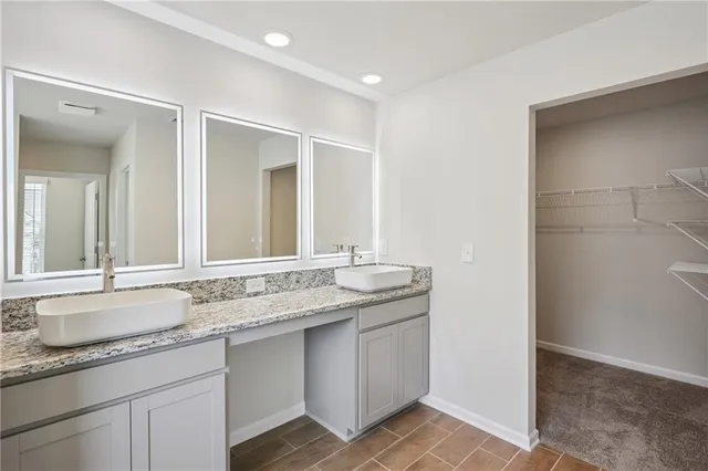 a white bath tub sitting next to a white sink
