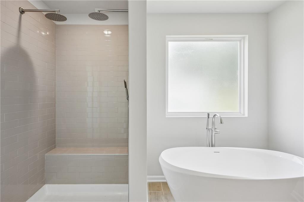 685 Egrets Landing, Unit 58 Covington, GA 30014 - Photo 21 of 41 a white bath tub sitting next to a white sink