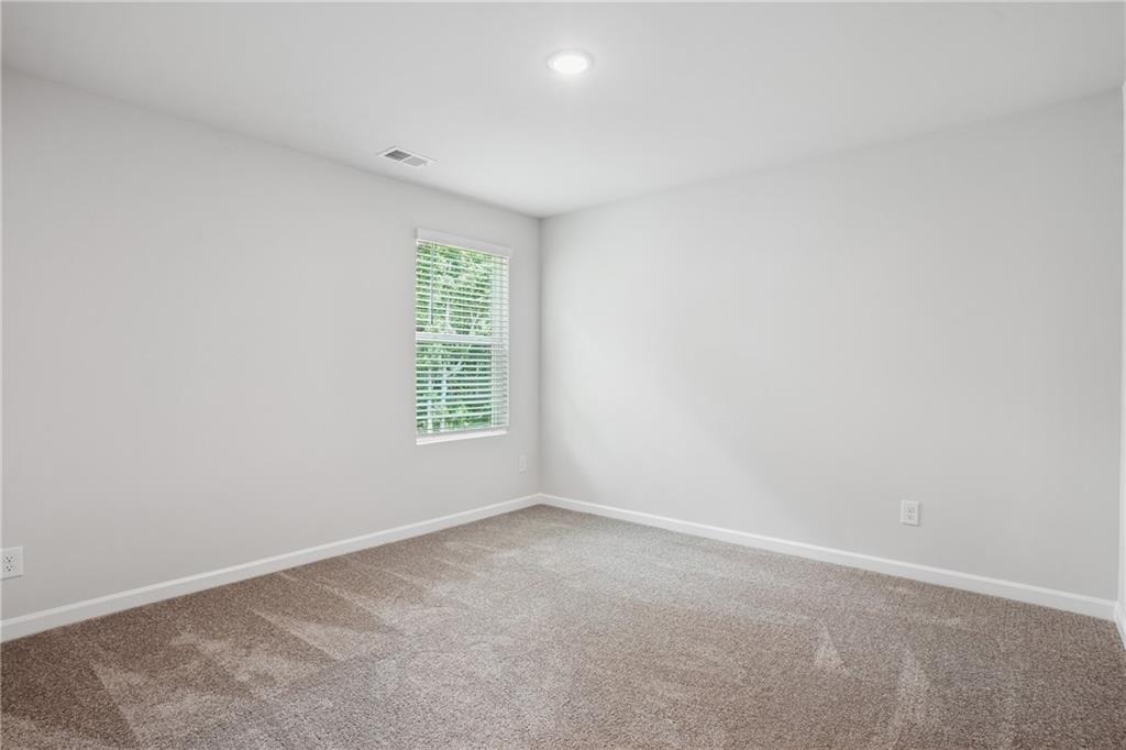 685 Egrets Landing, Unit 58 Covington, GA 30014 - Photo 26 of 41 an empty room with windows