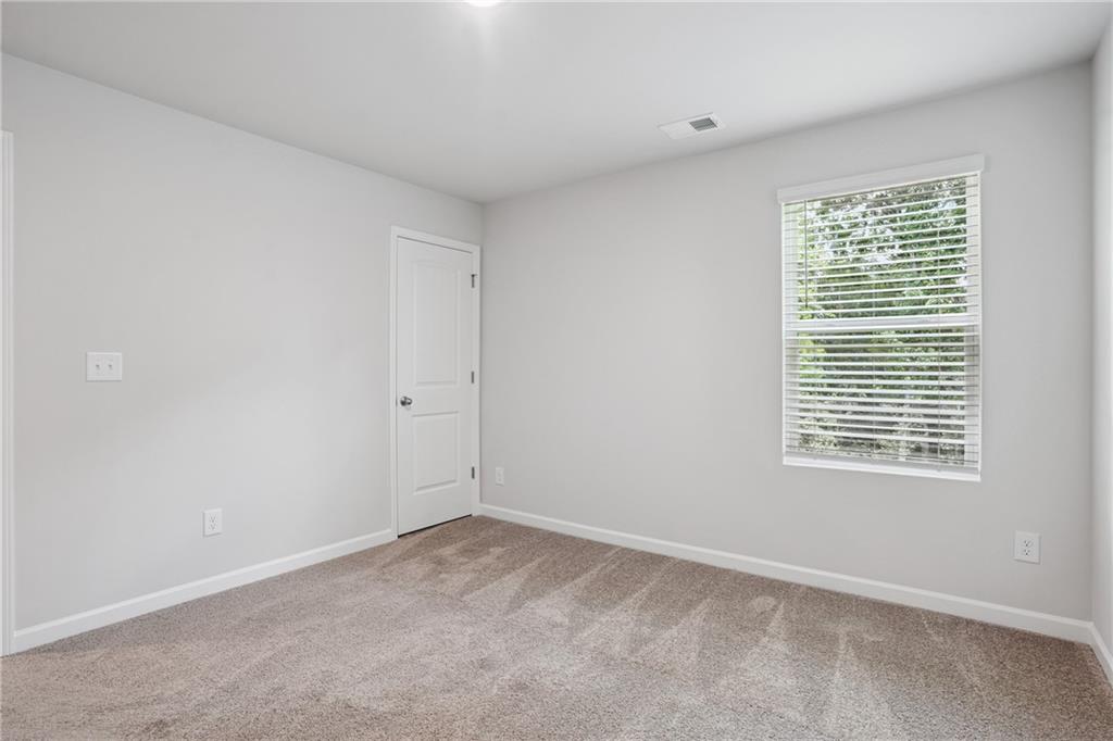 685 Egrets Landing, Unit 58 Covington, GA 30014 - Photo 27 of 41 a view of a room that has a window in it