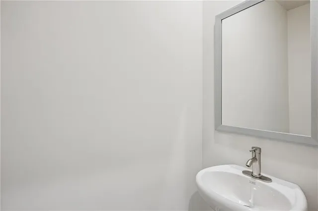 an aerial view of a swimming pool with a yard and seating space