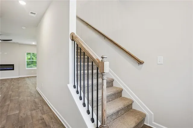 a view of entryway and hall with wooden floor