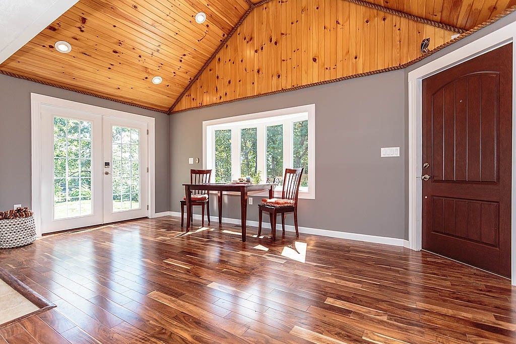 9 Arbor Road Chelmsford, MA 01863 - Photo 2 of 25 a dining room with wooden floor a chandelier a wooden table and chairs