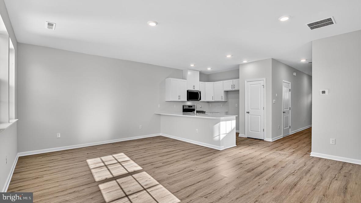 204 Bentz Avenue Villas, NJ 08251 - Photo 6 of 22 a large white kitchen with a refrigerator and white cabinets