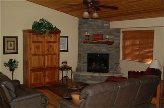 7168 Moon Pinetop, AZ 85935 - Photo 2 of 5 a living room with furniture and a fireplace