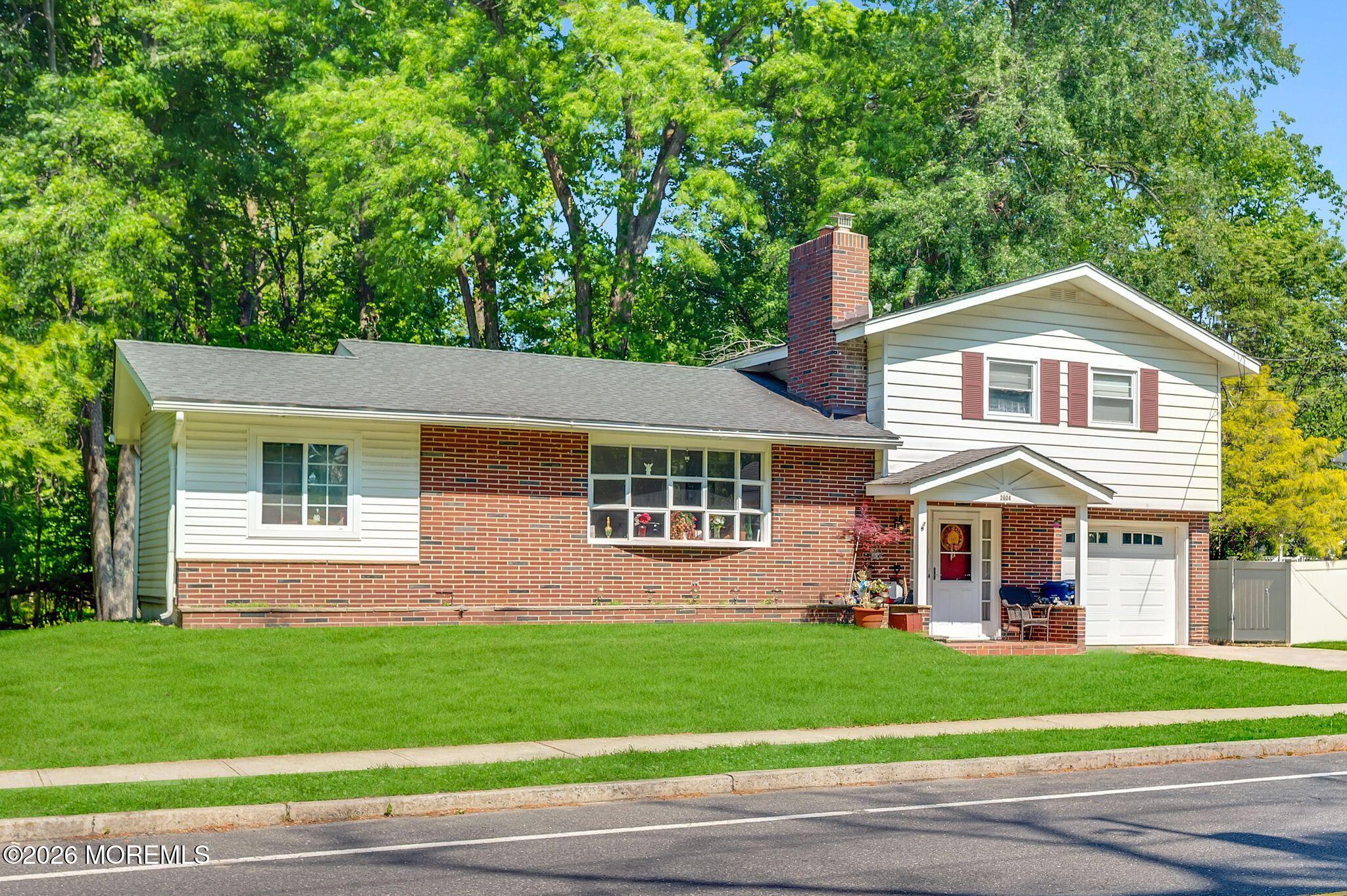 2604 Logan Road Asbury Park, NJ 07712 - Photo 2 of 39 a front view of a house with a garden