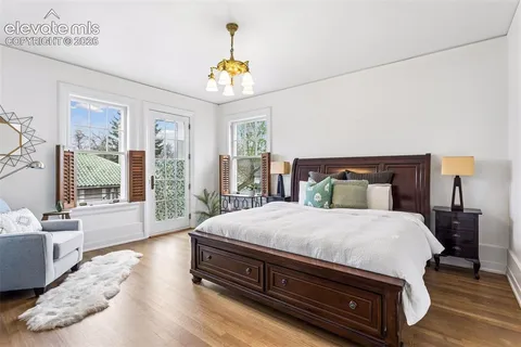 a bedroom with furniture and a wooden floor