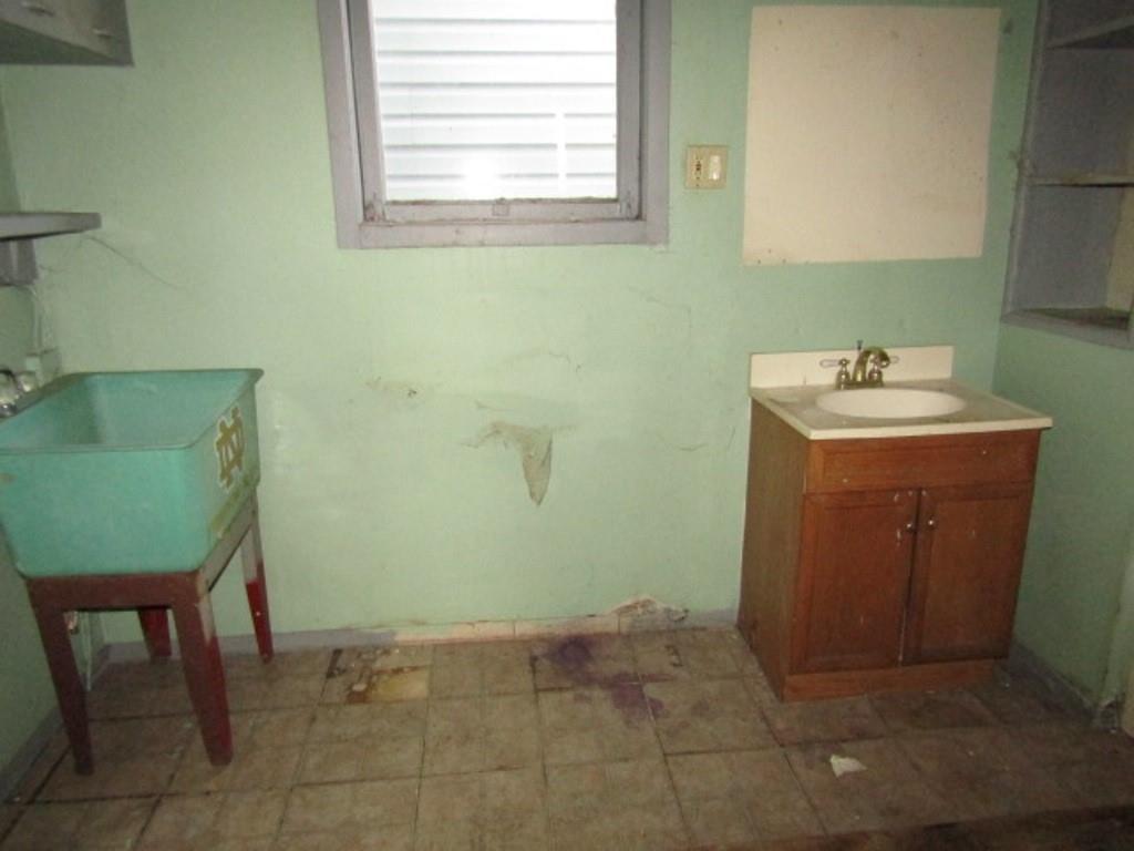 1817 4th Avenue Beaver Falls, PA 15010 - Photo 16 of 33 a bathroom with a sink a toilet and mirror