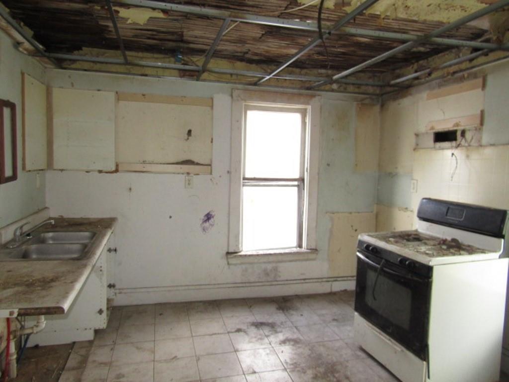 1817 4th Avenue Beaver Falls, PA 15010 - Photo 28 of 33 a kitchen with a stove a sink and a microwave