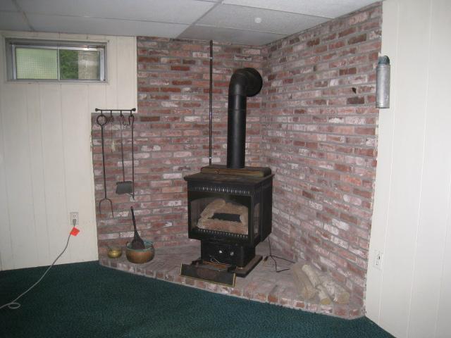 20 Farm Hill Road Centerville, MA 02632 - Photo 23 of 33 a room with water heater and wooden cabinets