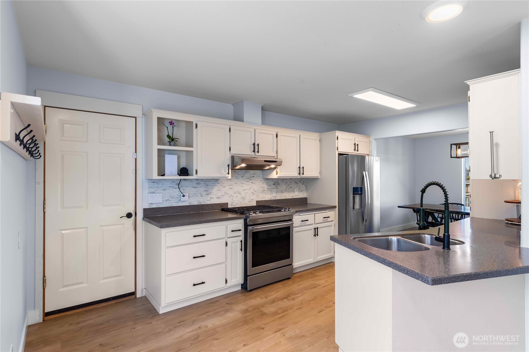 1608 Southwest Union Street Oak Harbor, WA 98277 - Photo 11 of 40 a kitchen with stainless steel appliances granite countertop a sink stove and refrigerator