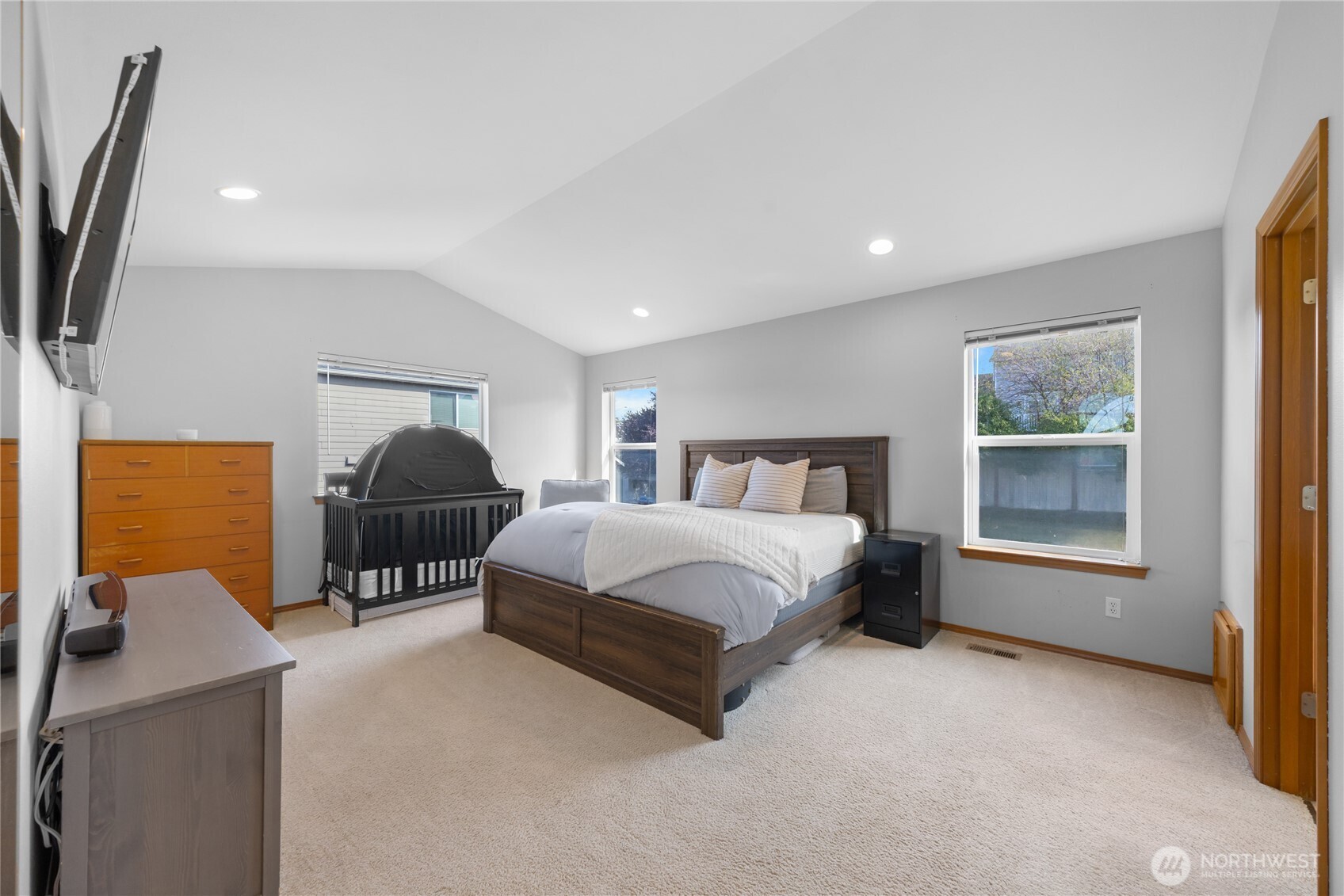 1608 Southwest Union Street Oak Harbor, WA 98277 - Photo 17 of 40 a spacious bedroom with a bed and a flat tv screen on dresser
