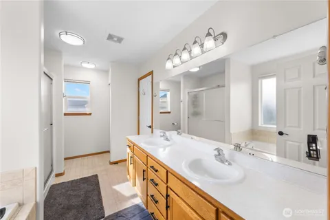 a spacious bathroom with a double vanity sink mirror and double