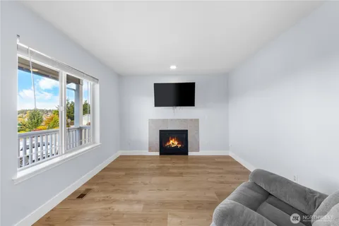 a living room with furniture flat screen tv and a fireplace