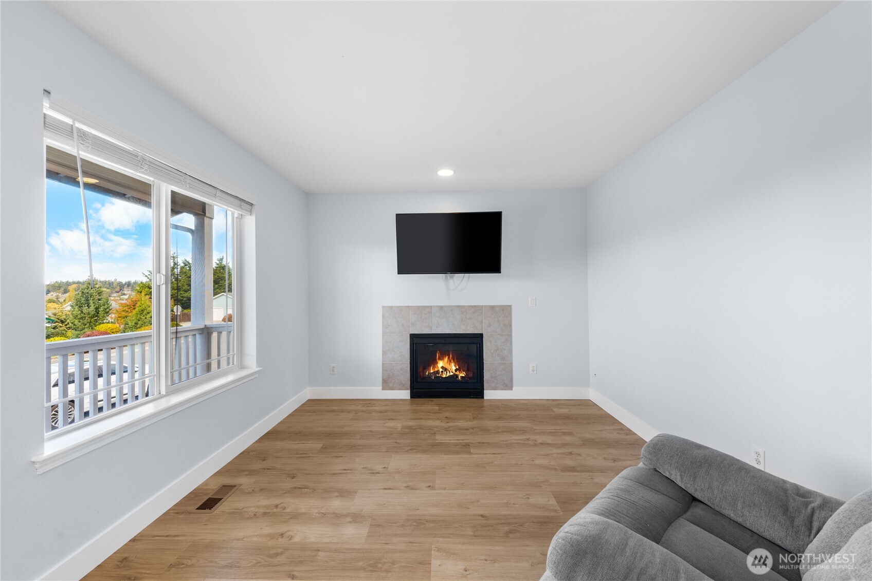 1608 Southwest Union Street Oak Harbor, WA 98277 - Photo 2 of 40 a living room with furniture flat screen tv and a fireplace