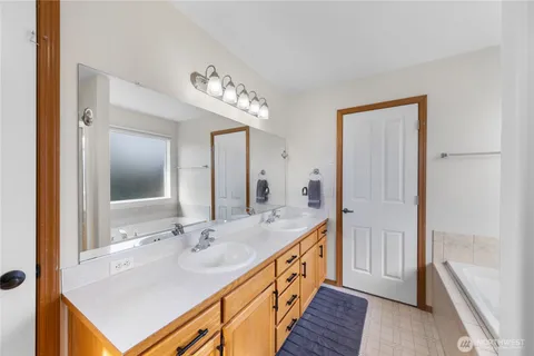 a bathroom with a sink a mirror and a shower