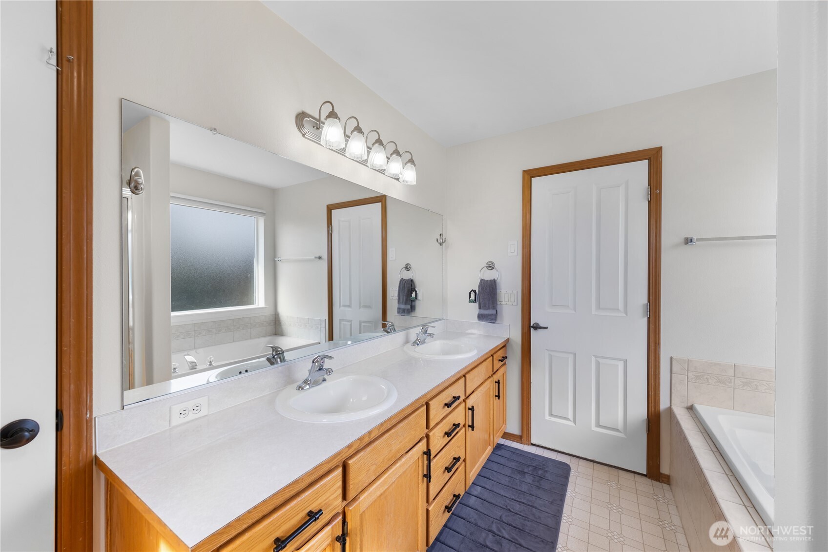 1608 Southwest Union Street Oak Harbor, WA 98277 - Photo 22 of 40 a bathroom with a sink a mirror and a shower